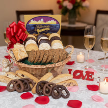 Load image into Gallery viewer, cookie and pretzel gift basket tripician's brand on a table withvalentine's decorations, an angel and champagne glasses.