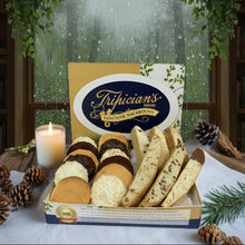 Load image into Gallery viewer, Box of Tripician's biscotti with a candle and pinecones on a decorative background