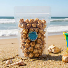 Load image into Gallery viewer, Upright clear resealable bags of caramel popcorn with a Tripicians brand round label