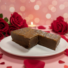 Load image into Gallery viewer, A piece of chocolate fudge with caramel and sea salt sprinkled on top