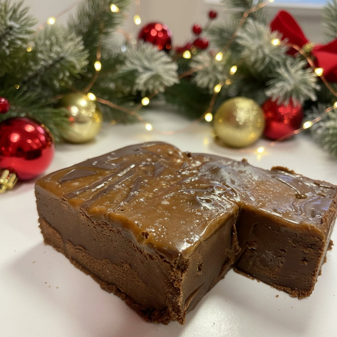 A piece of chocolate fudge with caramel and sea salt sprinkled on top