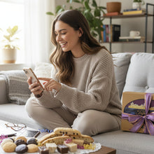 Load image into Gallery viewer, Assorted cookies and macarons on a white doily with a Tripician's box in the background.
