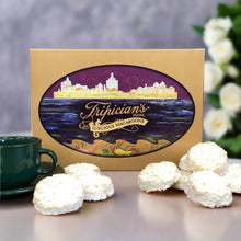 Load image into Gallery viewer, Coconut Macaroons Tripician branded on a table with a green cup of coffee
